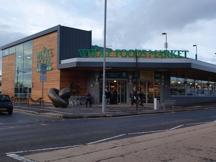 Whole Foods Market exterior at twilight with store lights visible
